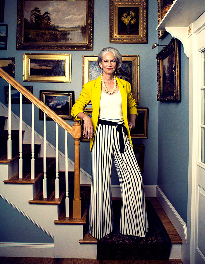 Woman in yellow jacket on staircase